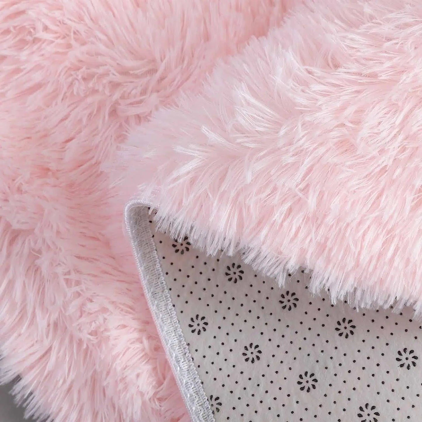 Sous-face antidérapante à motif fleurs du tapis rond rose poil long