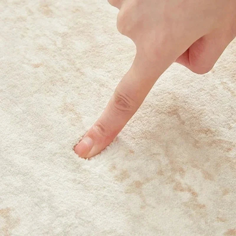 Toucher du velours dense du tapis rond beige minimaliste marbré