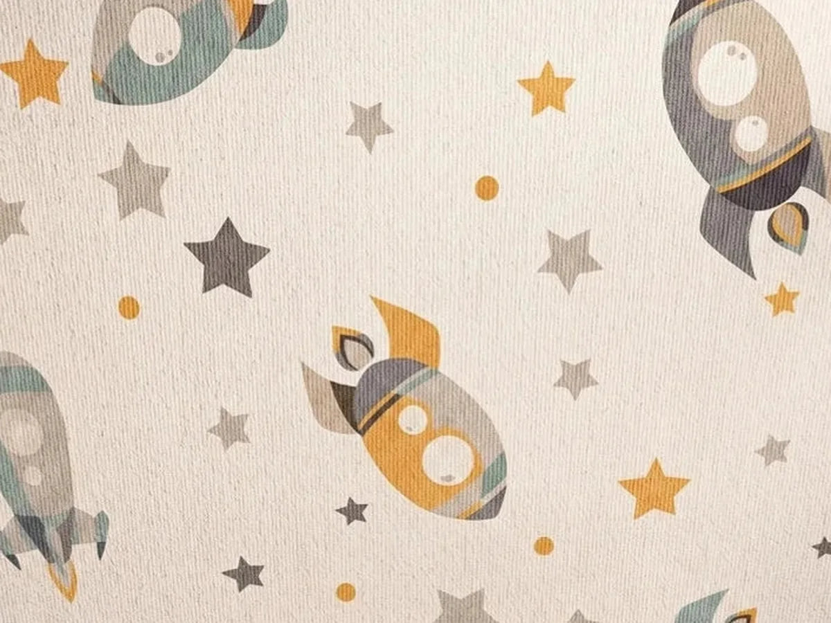 Vue rapprochée du motif et de la texture du tapis rond enfant fusées et étoiles