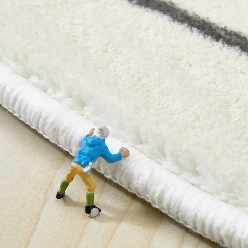 Détail du toucher de la fibre du tapis illustré avec une figurine miniature