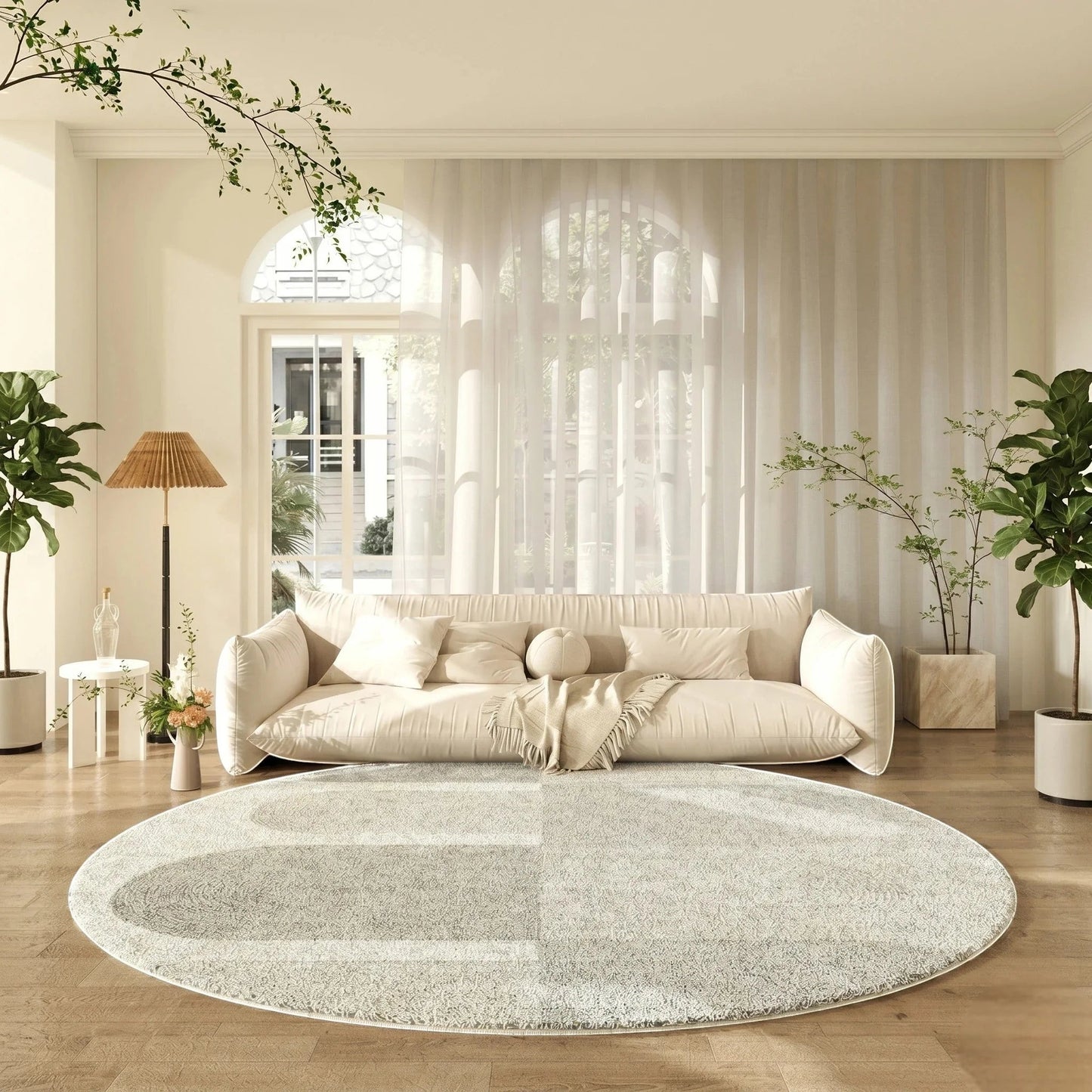 Tapis rond gris clair tracé organique dans un salon lumineux avec canapé crème et grande baie vitrée arquée