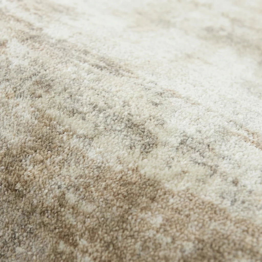 Velours imitation cachemire du tapis rond beige patiné vu de près