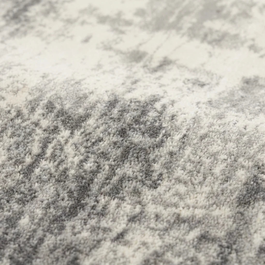 Velours imitation cachemire du tapis rond gris effet béton vu de près