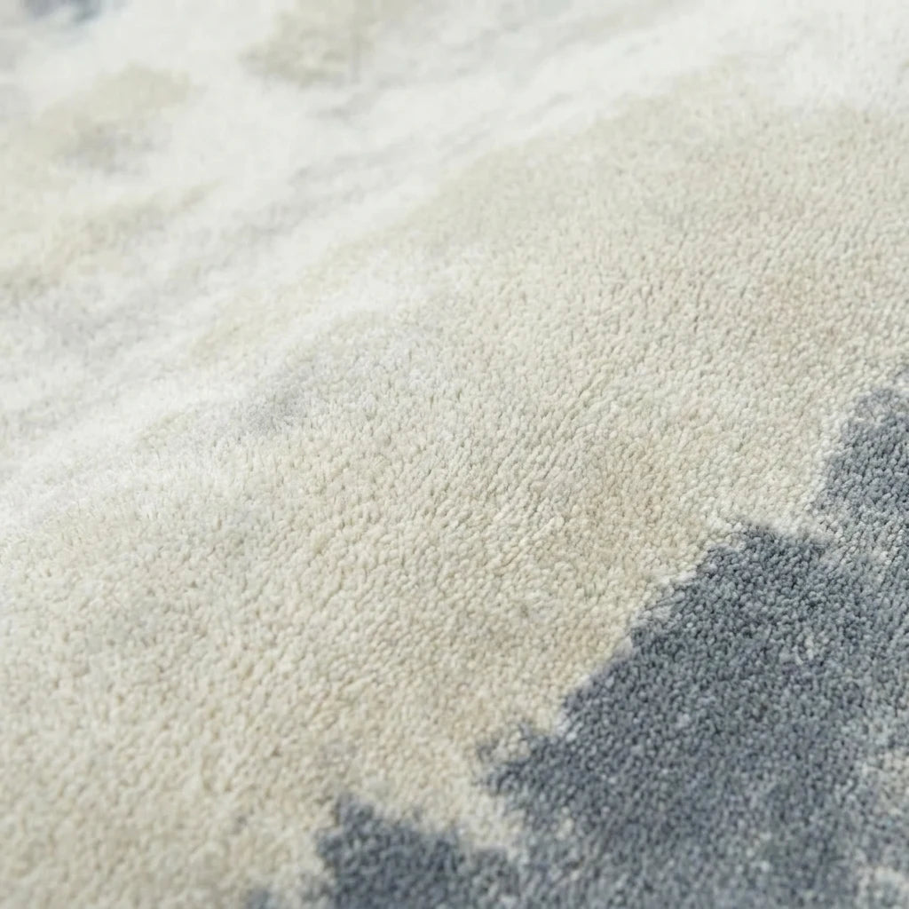 Velours imitation cachemire du tapis rond gris nuagé vu de près