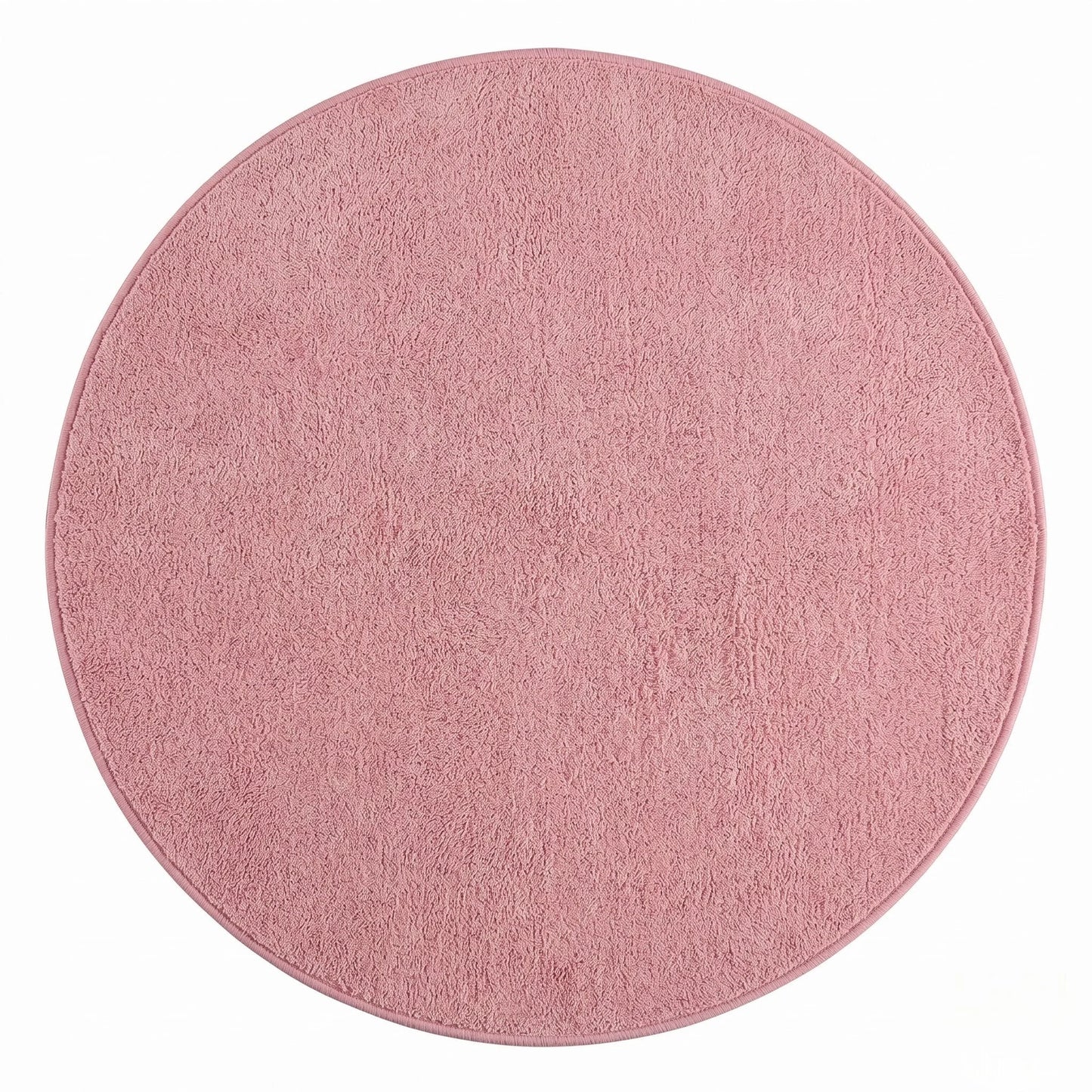 Vue studio du tapis rond rose poudré en peluche microfibre douce