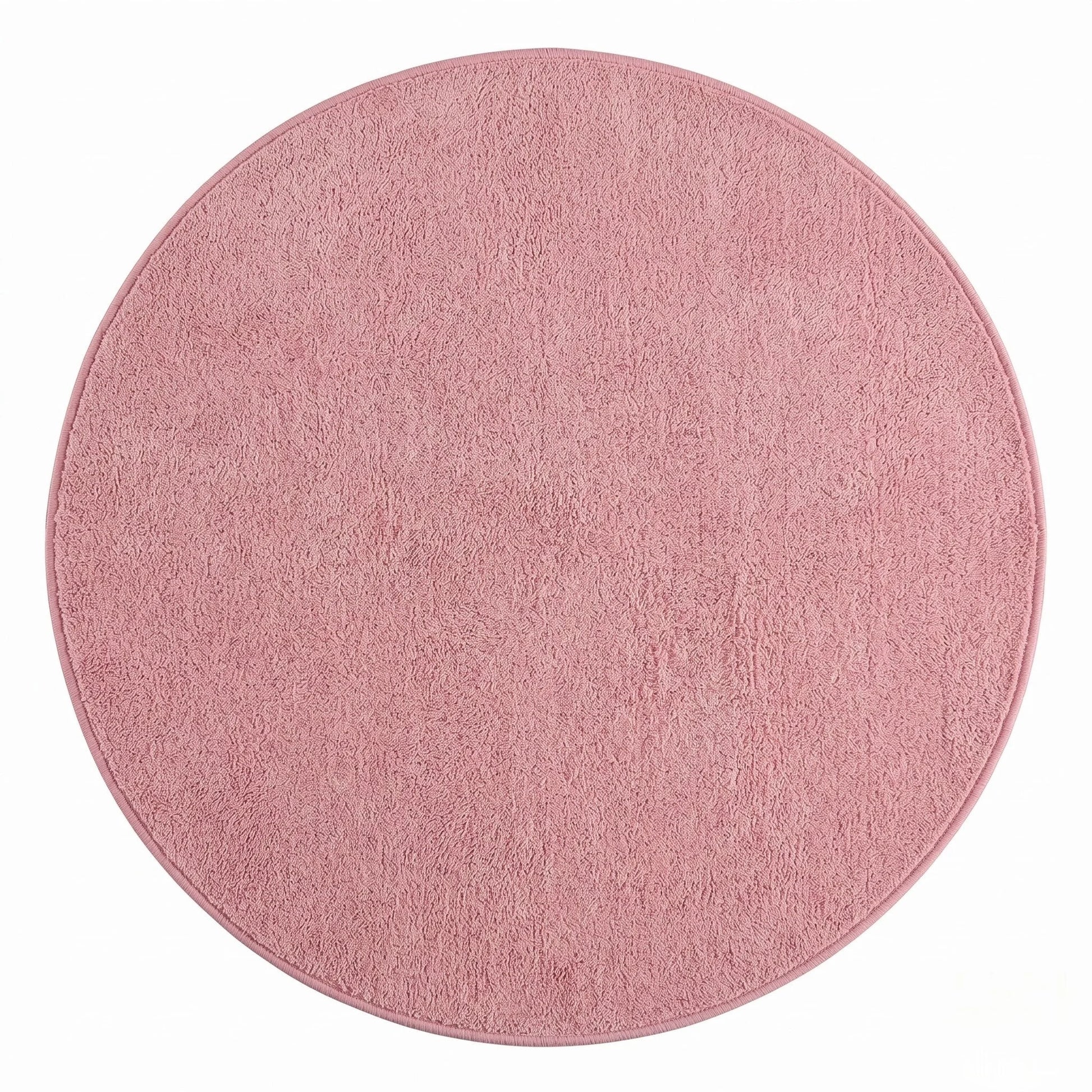 Vue studio du tapis rond rose poudré en peluche microfibre douce