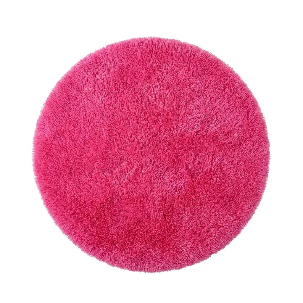 Vue studio du tapis rond salle de bain moelleux rose sur fond blanc, peluche dense poil long