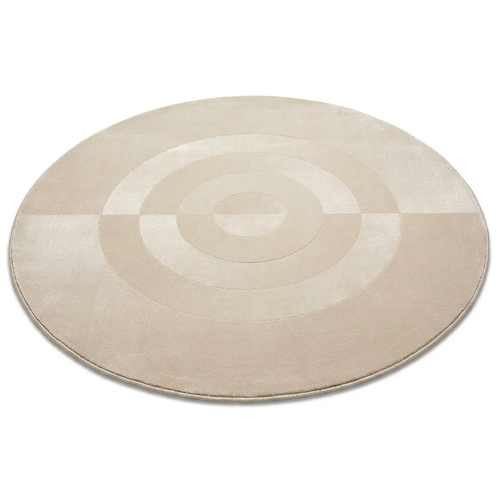 Vue studio du tapis rond salon cercles concentriques beige crème, fond blanc, épaisseur visible
