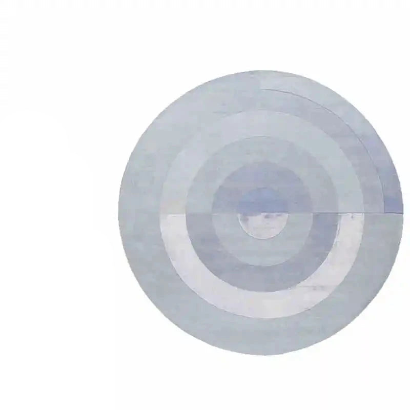Photo originale du tapis rond salon cercles concentriques bleu gris, vue top-down studio