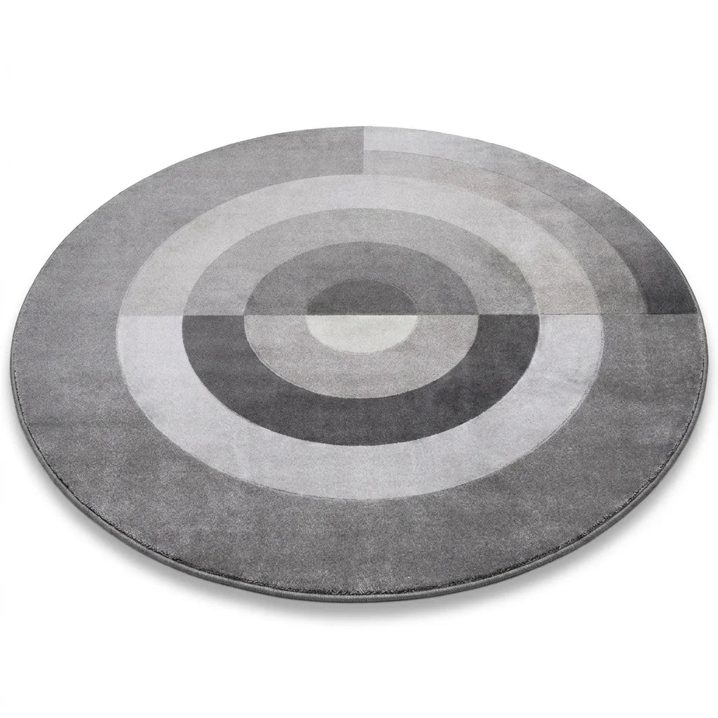 Vue studio du tapis rond salon cercles concentriques gris, fond blanc, épaisseur visible